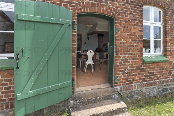 View from the garden into the kitchen of the historic farmhouse from the 19th century, Open-Air