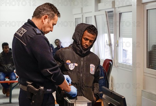 Refugees are registered and recorded by the Federal Police in Rosenheim. A Federal Police officer
