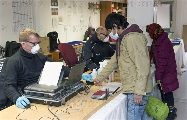 Refugees are registered and recorded by the Federal Police in Rosenheim. A Federal Police officer