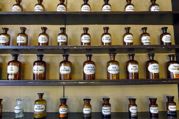 Containers with ingredients for medicines stand on a shelf in the historic Berg-Apotheke pharmacy