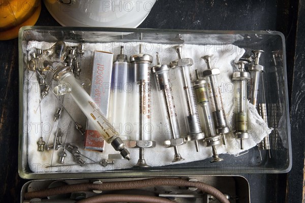 Old syringes in a bowl stand in the former laboratory of the historic Berg-Apotheke pharmacy in
