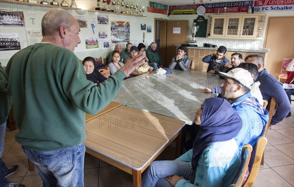 Syrian refugees learn traffic rules during an integration course. An employee of the