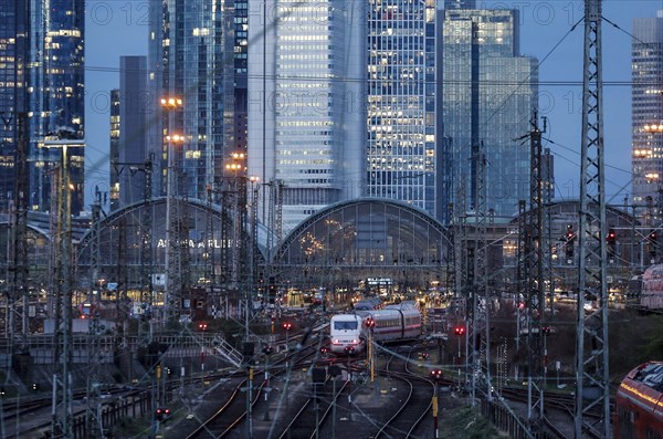 An ICE train leaves Frankfurt Central Station, the Frankfurt skyline with skyscrapers in the