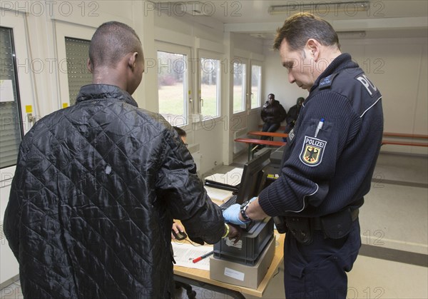 Refugees are registered and recorded by the Federal Police in Rosenheim. A Federal Police officer