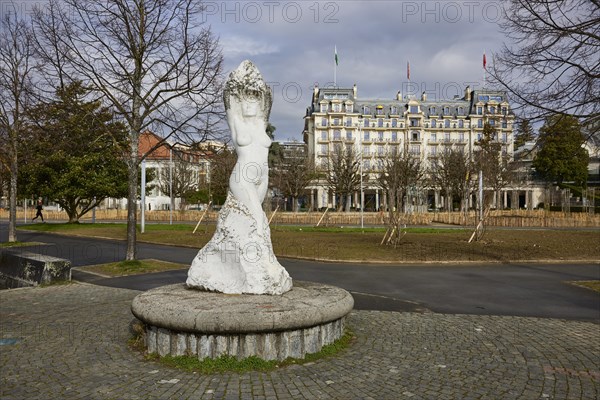 Statue of the Virgin of Lake Geneva, Vierge du Lac and the Hotel Beau-Rivage Palace in the Ouchy