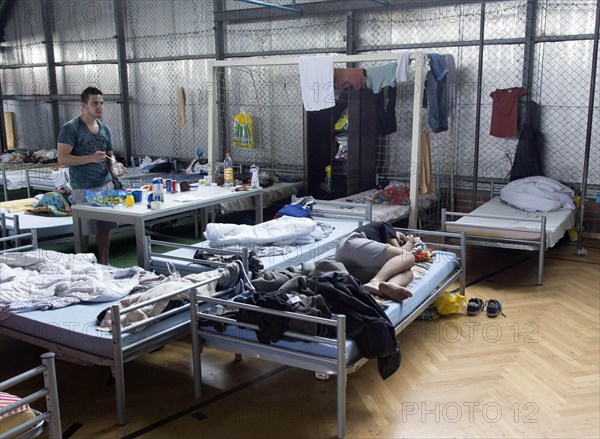 Refugees from Syria are housed in a gymnasium at the central contact point for asylum seekers in