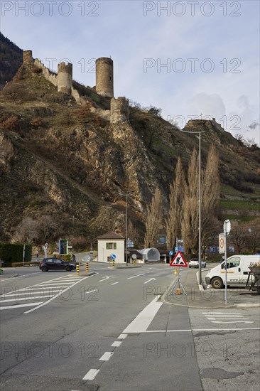 Saillon Castle with the Bayart tower and road in Saillon, district of Martigny, canton of Valais,