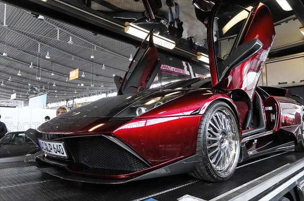 RETRO CLASSICS 2010, Stuttgart Messe, A red luxury sports car with open gullwing doors at a motor
