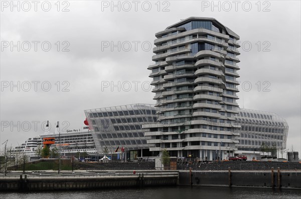 Marco Polo Tower, cruise ship behind a modern building facade on a cloudy day, Hamburg, Hanseatic