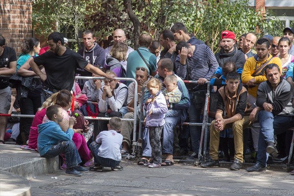 Refugees from Syria wait behind barriers in the central reception centre for asylum seekers at the