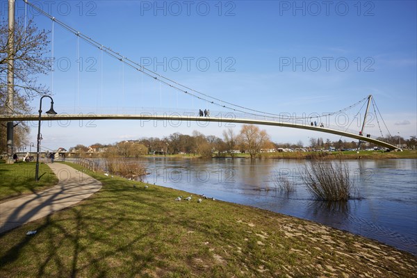 The curved suspension bridge designed by Joerg Schlaich, called Glacisbruecke, crosses the Weser