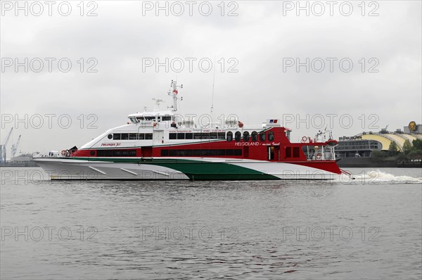 Red and white catamaran on calm waters named 'Halunder Jet', Hamburg, Hanseatic City of Hamburg,