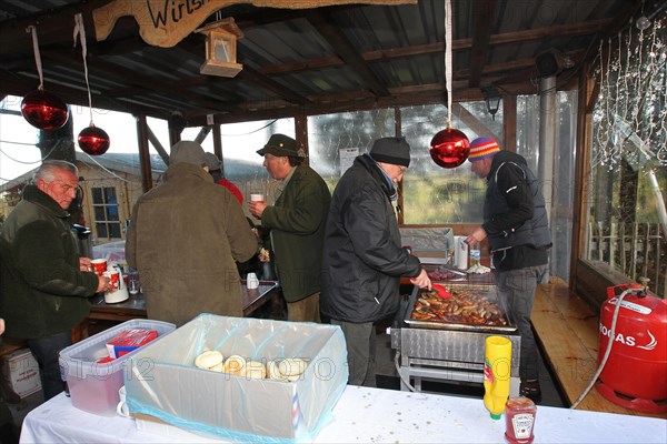 Wild boar (Sus scrofa) End of the hunt, cosy get-together, so-called Schuesseltreiben, tradition,
