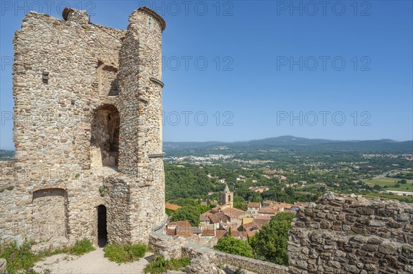 Ruins of Grimaud Castle with a view of the village of Grimaud, in the background the hills of the