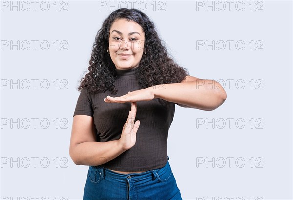 Smiling woman showing time out gesture isolated. Young woman making time out gesture with palms