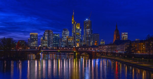 The Frankfurt skyline with office tower blocks behind the Main at blue hour after sunset, on the