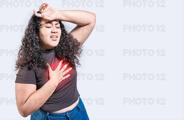 People with heart problems isolated. Latin woman with heart pain on isolated background. Young
