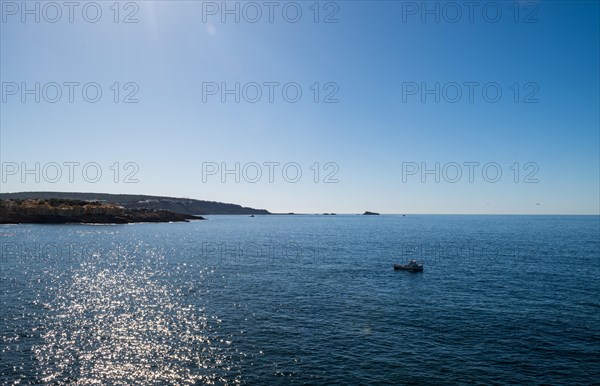View of the sea with fishing boat from the Mirador de les Malgrats near Santa Ponca or Santa Ponsa,