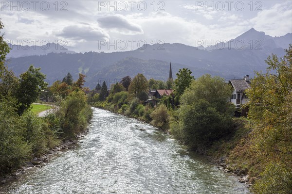 Loisach with houses, old parish church St. Martin, Wetterstein mountains with alpine seats,