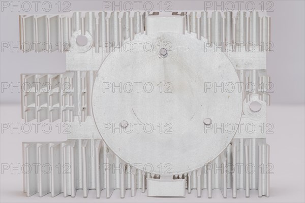 Closeup of fins and fan mounting surface of rectangle aluminum heat sink on white background