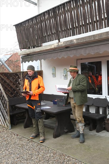 Wild boar (Sus scrofa) Hunting master and professional hunter give a speech in front of the start