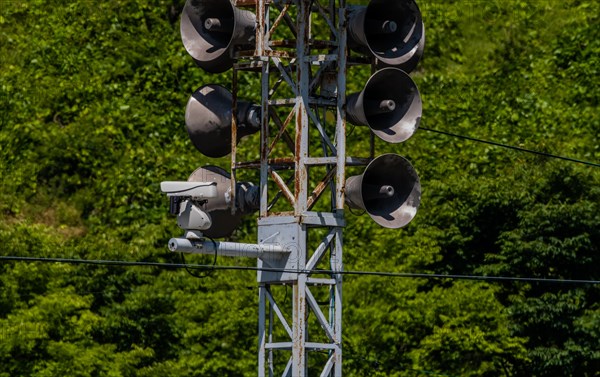 Communication tower consisting of loud speakers, solar panel and closed circuit camera with tree