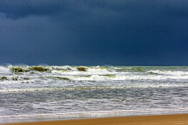 Dark rain clouds over the waters of Sargi beach in Serra Grande on the coast of Bahia, Bahia,