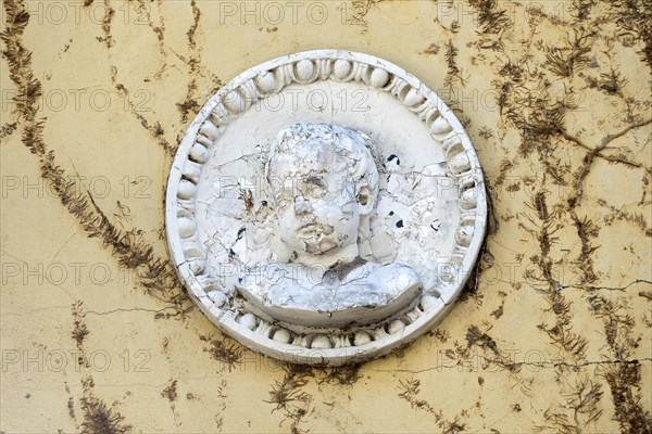 Decorative medallion in Art Nouveau style, relief portrait of a boy, facade of the Ulenspiegel,