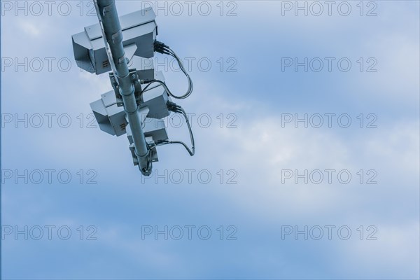Speed radar cameras mounted on metal pole against blue sky with puffy white clouds in Daejeon,