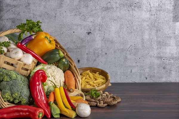 Various fresh vegetables such as peppers, cauliflower, peppers, mushrooms and broccoli in a basket