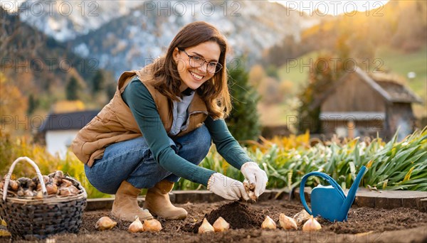 Smiling woman planting flower bulbs in an idyllic garden with mountain view in autumn, KI