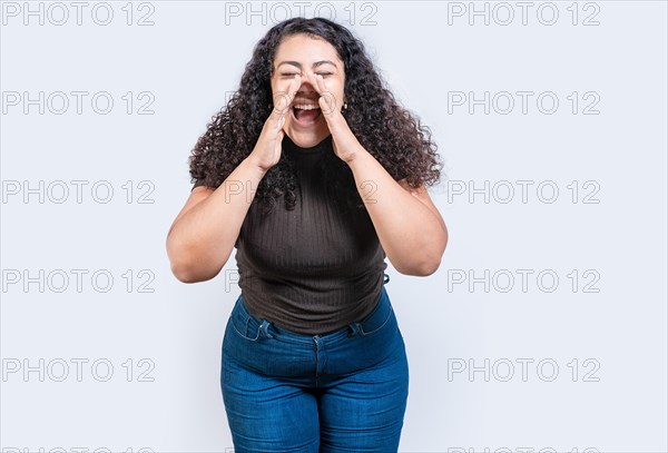 Beautiful girl announcing something to the camera isolated. Young girl screaming and announcing