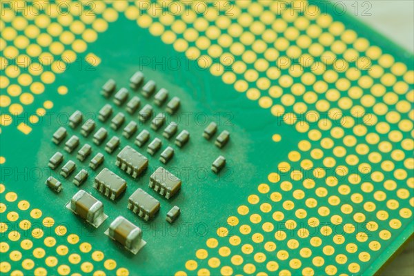 Extreme closeup of Central processor unit (CPU) detailing the individual chips and gold connection