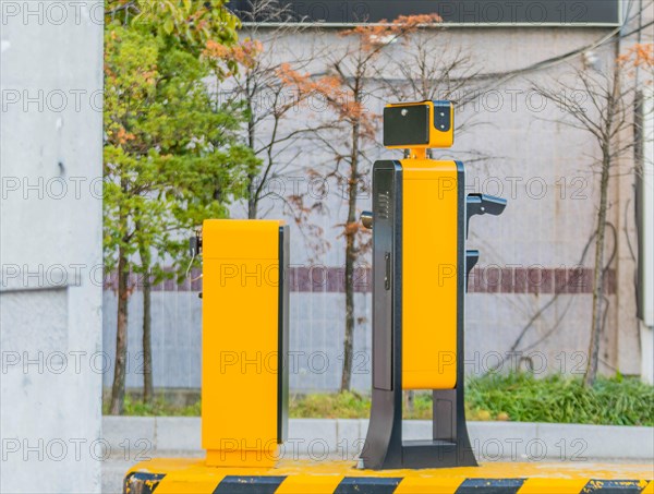 Side view of device to read license plates and calculate charges as cars enter and exit parking