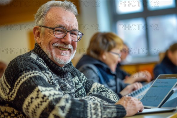 A man of advanced age, senior citizen, sitting with a digital tablet in a course room, training