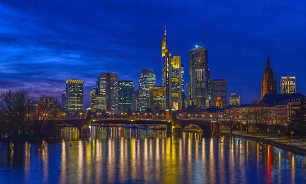 The Frankfurt skyline with office tower blocks behind the Main at blue hour after sunset, on the