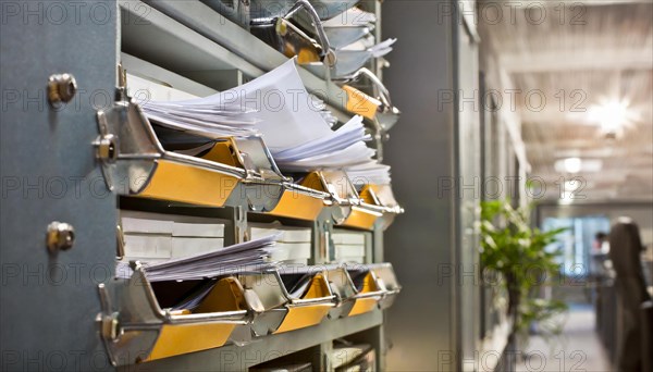 Wall mount with pockets full of documents and folders in an office, symbol bureaucracy, AI