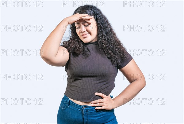 Tired and exhausted girl holding her forehead. Worried young woman holding his forehead. Exhausted