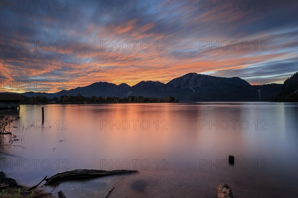 Dawn over a lake in front of mountains, long exposure, Lake Kochel, view of Rabenkopf and Jochberg,