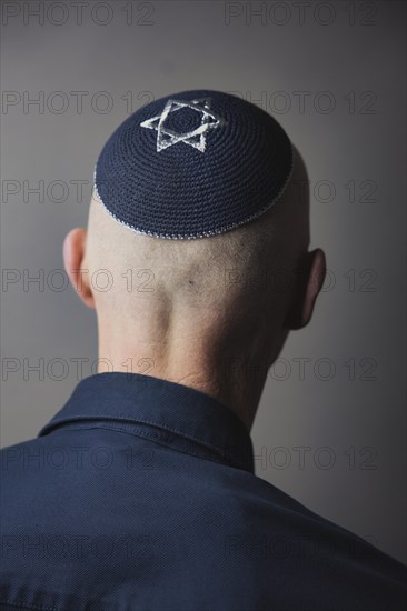Jewish man wearing a kippa with a Star of David on his head, back view, studio shot, Germany,