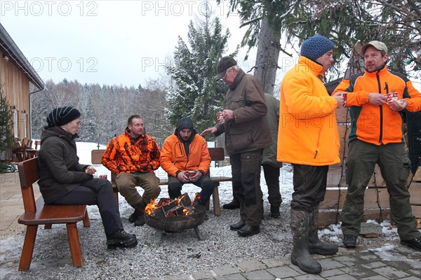 Wild boar (Sus scrofa) end of the hunt, amusing hunter's round, so-called Schuesseltreiben,