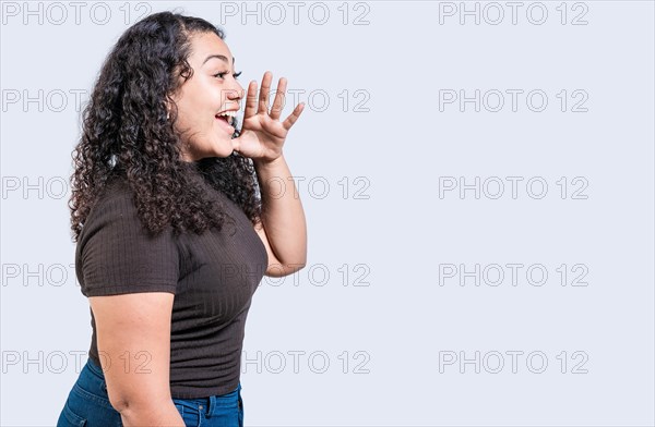 Happy girl announcing something isolated. Beautiful woman screaming and announcing an advertising