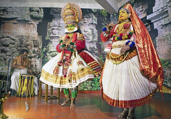Kathakali performer or mime, 38 and 60 years old, and drummer on stage at the Kochi Kathakali