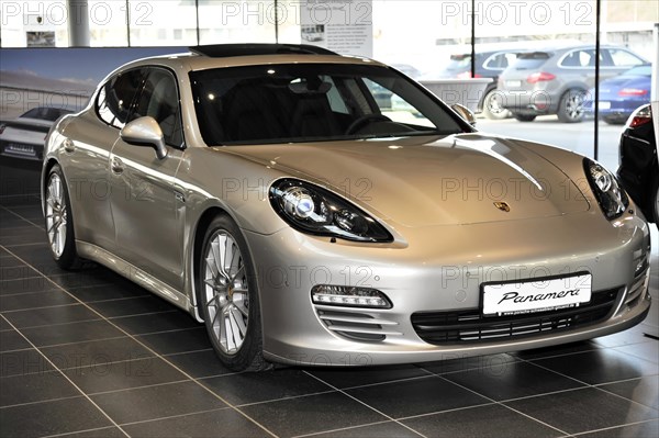 Silver Porsche Panamera in a showroom of a car dealership, Schwaebisch Gmuend, Baden-Wuerttemberg,