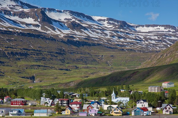 View over church and colourful houses in the town Seyoisfjoerour along the fjord Seydisfjoerdur in