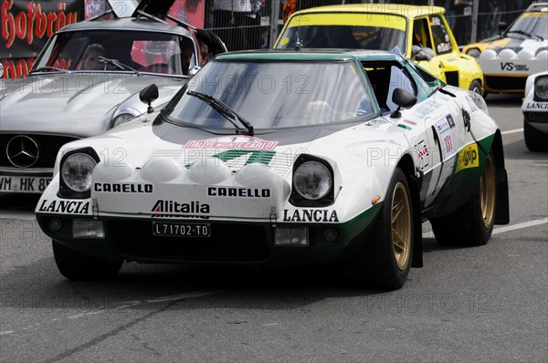 A white and green Lancia Stratos with the number 419 in rally livery at a race, SOLITUDE REVIVAL