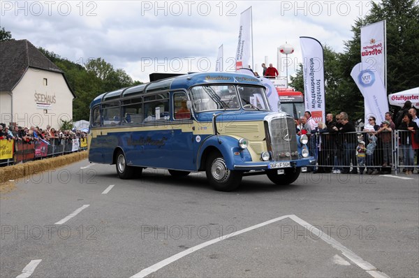 Mercedes-Benz O319, built in 1964, A vintage Mercedes-Benz bus in blue at a rally with an audience