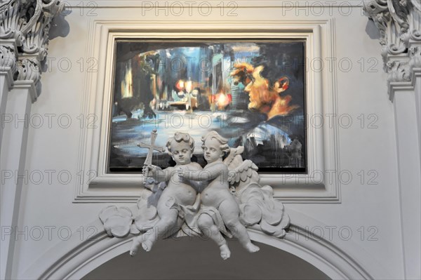 The Neumuenster Collegiate Abbey, Diocese of Wuerzburg, Two statues of angels with an abstract