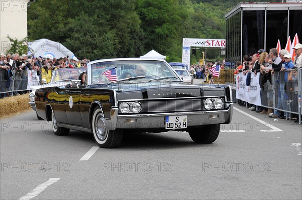 Black American convertible classic car with US flag in front of spectators, SOLITUDE REVIVAL 2011,