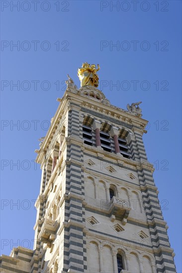 Church of Notre-Dame de la Garde, Marseille, Tower of a church with golden sculptures in front of a